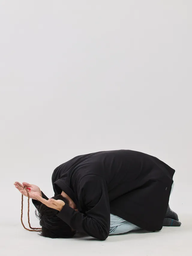 Billy Seol performing a full prostration with mala beads